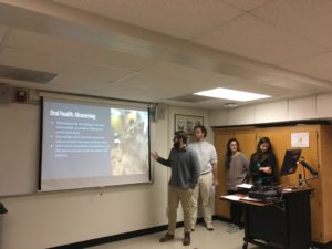 Image of students presenting on the probable diet and nutrition of the population in a classroom